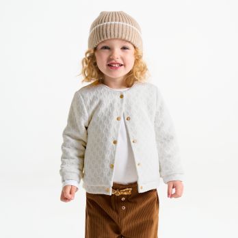 Baby girl's warm white fleece-lined knitted shiny cardigan.